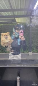 a woman taking a picture in a mirror with a dog at Love in Ban Khlong Chorakhe