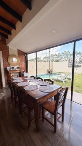 a dining room with a large wooden table and chairs at La casita de Ivanna in San Bernardino