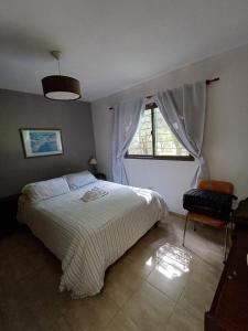 a bedroom with a large bed and a window at Las Guardia in Cortaderas +21 photos
