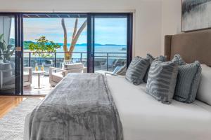 a bedroom with a bed with a view of the ocean at Shorelines Apartments on Hamilton Island by HIHA in Hamilton Island +154 photos