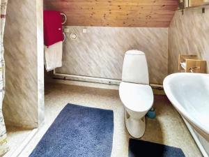 a bathroom with a white toilet and a sink at 4 star holiday home in ONSALA-By Traum in Onsala +24 photos