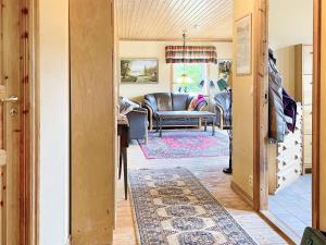 a living room with a leather chair and a couch at 4 star holiday home in ONSALA-By Traum in Onsala
