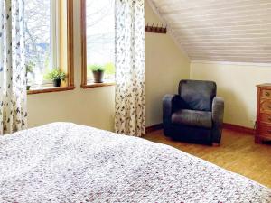 a bedroom with a bed and a chair and a window at 4 star holiday home in ONSALA-By Traum in Onsala