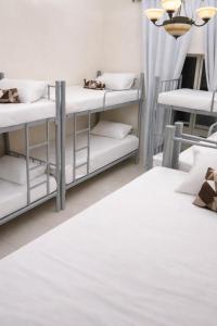 a room with bunk beds and a chandelier at ALEX Hostel - Bed in a shared room - H101 in Sharjah