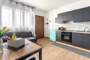 a kitchen and living room with a couch and a table at CasaTella Rose in Suite in Rosate