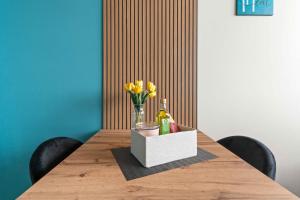 a table with a bottle of champagne and flowers on it at CasaTella Rose in Suite in Rosate