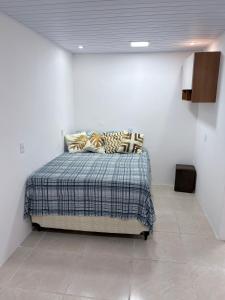 a bedroom with a bed in a white wall at The Brooklyn One in Salvador