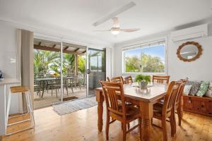 a dining room with a table and chairs at At The Beach in Lennox Head