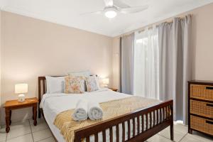 a bedroom with a bed with towels on it at At The Beach in Lennox Head +20 photos