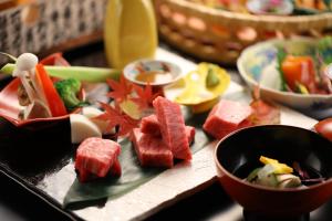 a tray with a bunch of food on a table at Hotel Tamanoyu in Matsumoto