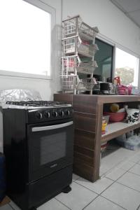 a kitchen with a stove and a counter with a mirror at Casa Belén in Flores +13 photos