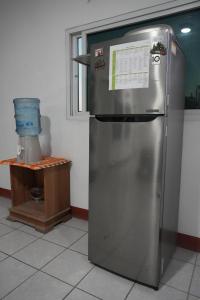 a stainless steel refrigerator in a kitchen with a window at Casa Belén in Flores