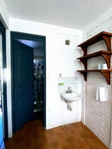 a bathroom with a sink and a blue door at Rent Casa La Moraleja in Ixtapa +14 photos
