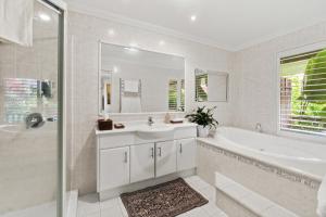 a white bathroom with a tub and a sink at Mountain Sanctuary Retreat in Mount Tamborine +55 photos