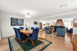 a dining room and living room with a table and chairs at Mountain Sanctuary Retreat in Mount Tamborine