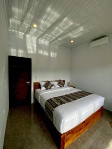 a bedroom with a large bed in a room at Adisamasta Guesthouse in Sidemen
