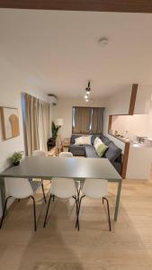 a living room with a table and a couch at Chill Place 120 Ayase in Tokyo