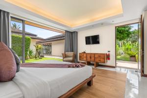 a bedroom with a bed and a sliding glass door at Baan Leelawadee in Bophut