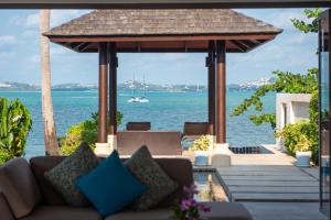 a living room with a couch and a view of the water at Baan Leelawadee in Bophut