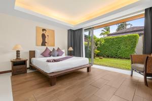 a bedroom with a bed and a large window at Baan Leelawadee in Bophut +19 photos