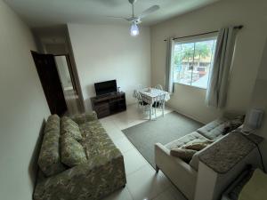a living room with a couch and a table at Casa e Mar Apto aconchegante perto da praia com estacionamento in São Pedro da Aldeia