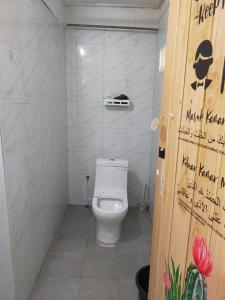a bathroom with a toilet in a small room at IdaSari Guest House Bukit Bunga in Kampong Bukit Bunga