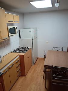 a kitchen with a white refrigerator and a table at Casa de alojados in Antofagasta