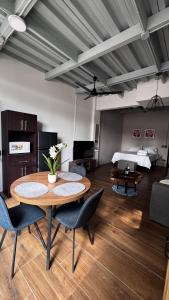 a living room with a table and chairs and a bed at GZ Suites in Coco