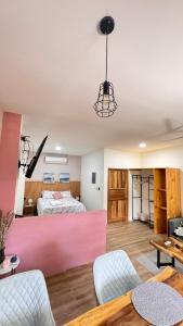 a bedroom with a bed and a pink wall at GZ Suites in Coco +34 photos