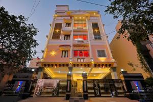 a tall white building with stairs in front of it at Aashi-Premium Serviced Apartments in Chennai