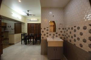 a bathroom with a sink and a mirror on the wall at Aashi-Premium Serviced Apartments in Chennai +32 photos