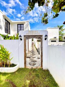 a entrance to a white house with a sign that reads private residence at Bukawa Residences Balangan in Jimbaran