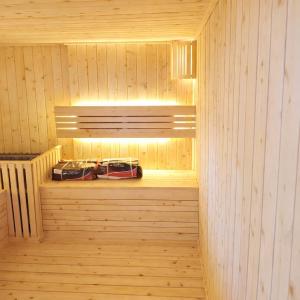a wooden sauna with two cars on the shelves at SanTran Hotel and Spa in Hai Phong
