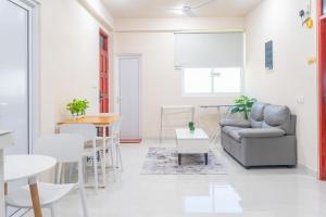 a living room with a couch and a table at Deam Stay in Kulhudhuffushi