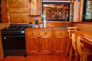 a kitchen with a stove and a sink at Casas Calenda in San Mateo Río Hondo +10 photos