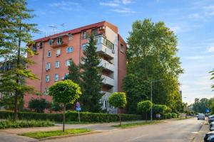 a building on the side of a street at Central Park Apartment in Čačak