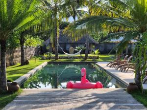 a pool with a float in the middle of a yard at Gili Dua Resort in Sekongkang