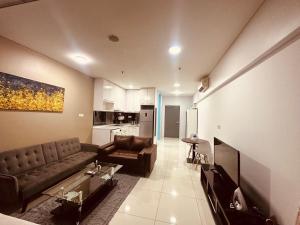 a living room with a couch and a table at Studio Apartment KLCC Area in Kuala Lumpur
