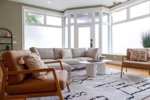 a living room with a couch and a table at Gorgeous 5BR Storefront Home ABODEbucks in Soulard