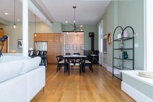 a dining room and living room with a table and chairs at Gorgeous 5BR Storefront Home ABODEbucks in Soulard