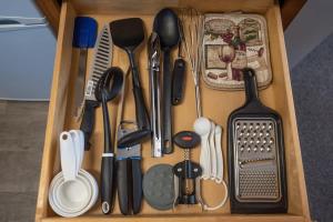 a wooden drawer filled with utensils and sidx sidx sidx at Riverside Cottage - Just Steps from the Deschutes in Bend +31 photos