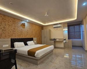 a bedroom with a large bed in a room at New KR Inn in Mālūr