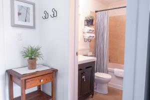 a bathroom with a sink and a toilet and a shower at Wanderlust Studio Suite with Private Patio in Harrison Hot Springs +49 photos