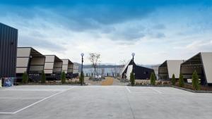 a parking lot in front of a large building at Gyeongju raon glamping in Samgong