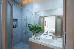 a bathroom with a sink and a shower and a mirror at Villa LaMoon in Sattahip +35 photos
