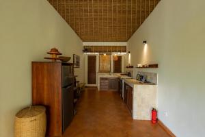 a kitchen with a counter and a kitchen with a sink at Flor Villa by Betterplace in Dalung
