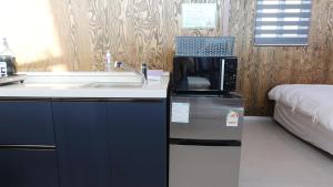 a kitchen with a sink and a microwave at Gyeongju raon glamping in Samgong +104 photos