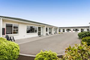 an empty parking lot in front of a building at Avon Motel in Hawera