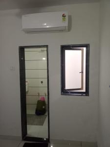 a bathroom with a mirror and a window at Keshav femely banglow in Dwarka