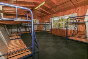 a large room with bunk beds in a building at Rotoiti Lodge in Saint Arnaud